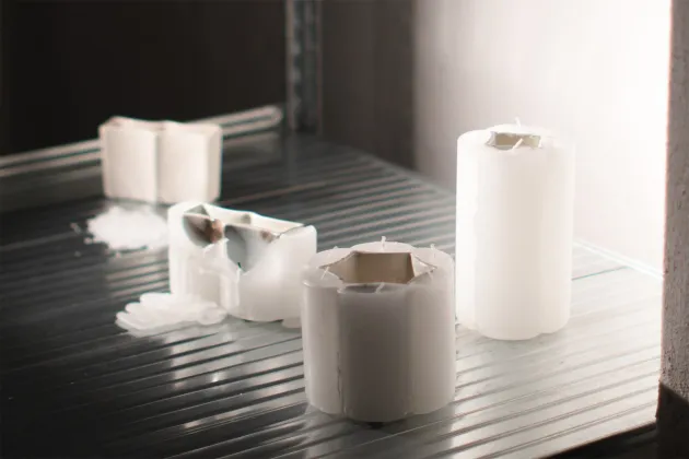 partly burned candles showing a metal inside. Photo. 