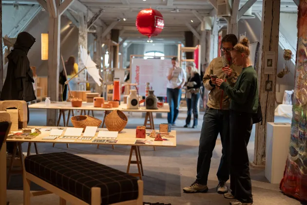 Exhibition hall with visitors. Photo.