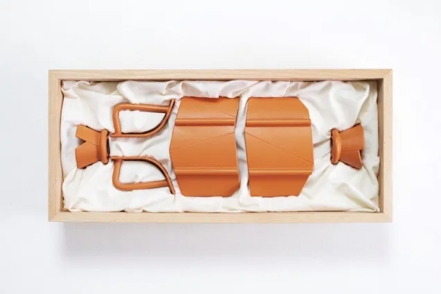 fragmented amphora shape in a wooden box