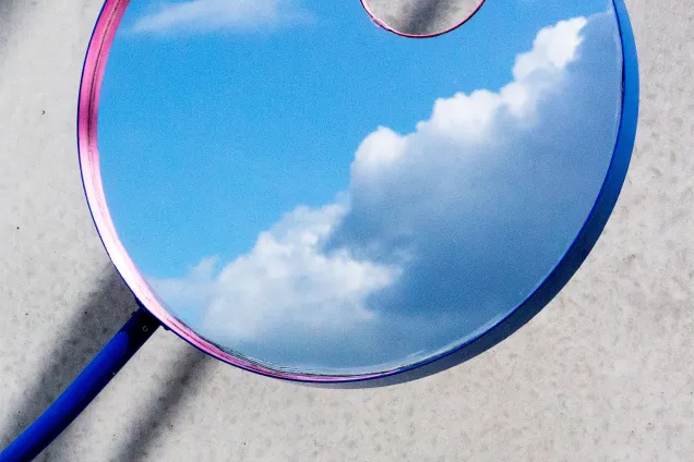 a mirror reflecting clouds. 