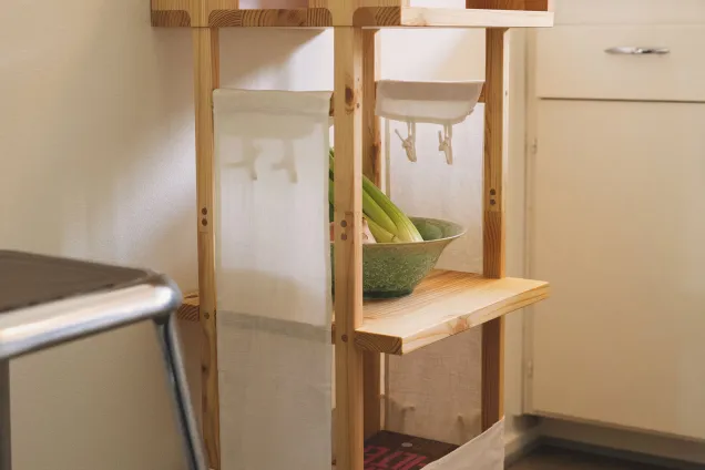 a wooden side table with fabric sides.