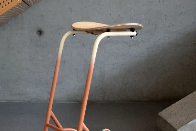 a seat with a metal frame and wheels. 