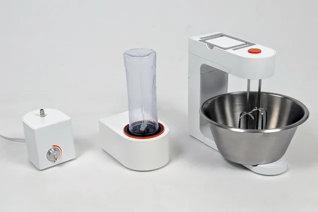 A series of three white kitchen appliances sitting in line. Photo. 