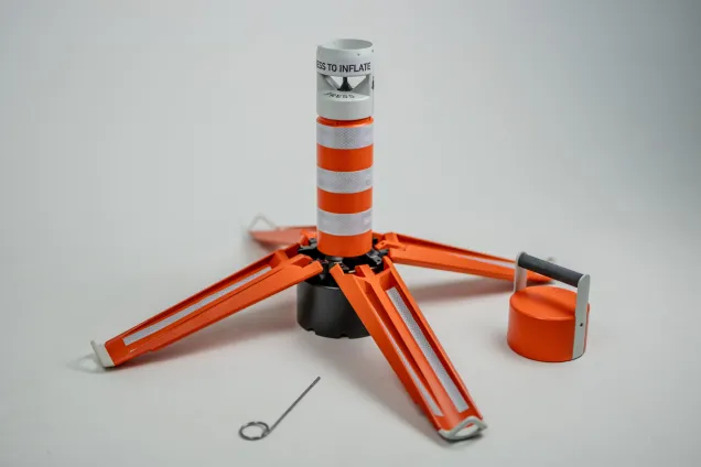 Orange object with four sides folded out as stabilizers. Photo. 