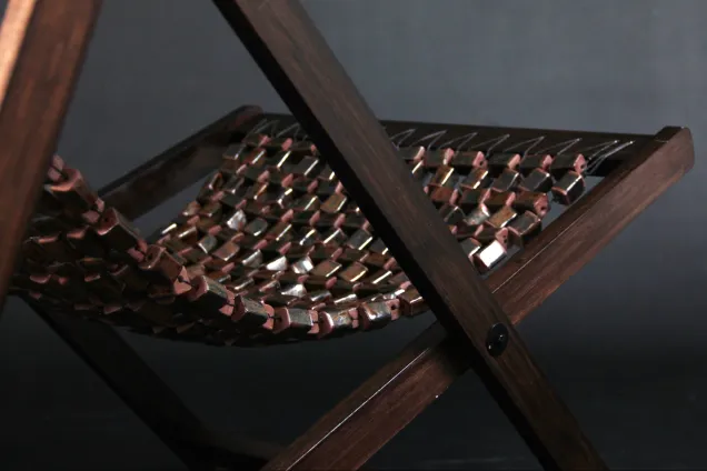 lounge chair with woven ceramic net seating. Photo. 