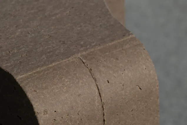 curved object made of cardboard pulp. Photo. 