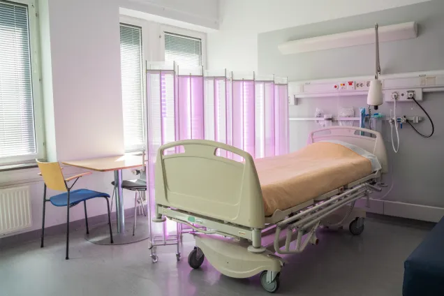Solace separating patient bed from table. Photo. 