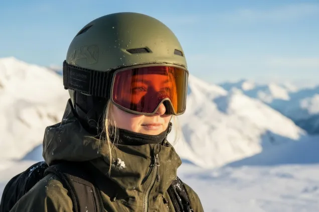 Skier with olive green helmet on. AI-generated photo.