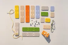 colorful flat blocks with holes and strings. Photo. 