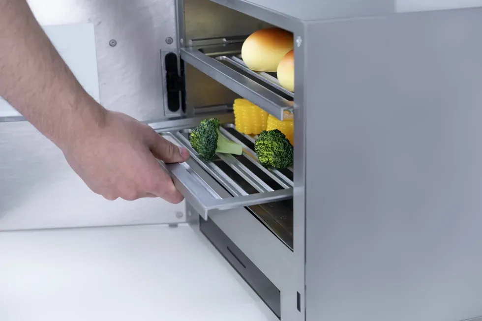 person putting a tray in the oven