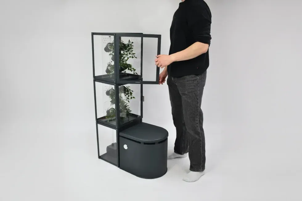 person opening the plant cabinet of the toilet