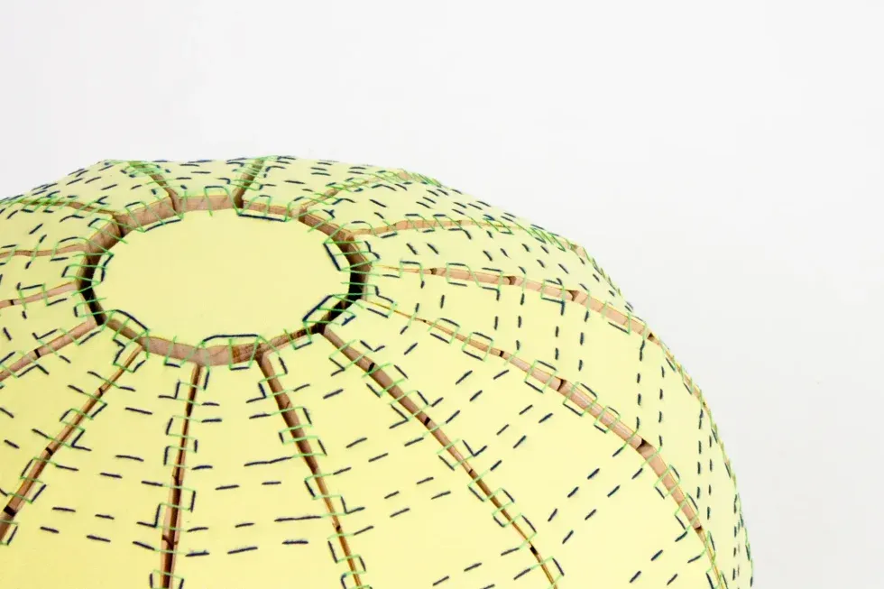 tiled seating pouf yellow with green stitching