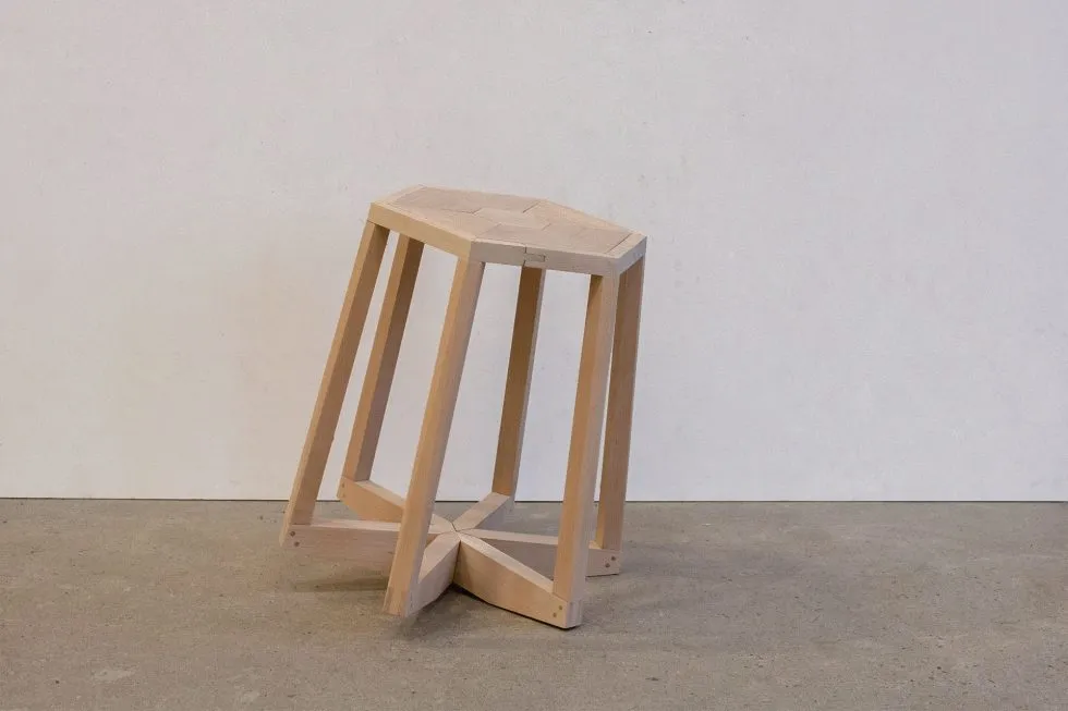 a wooden stool with an off center balance point