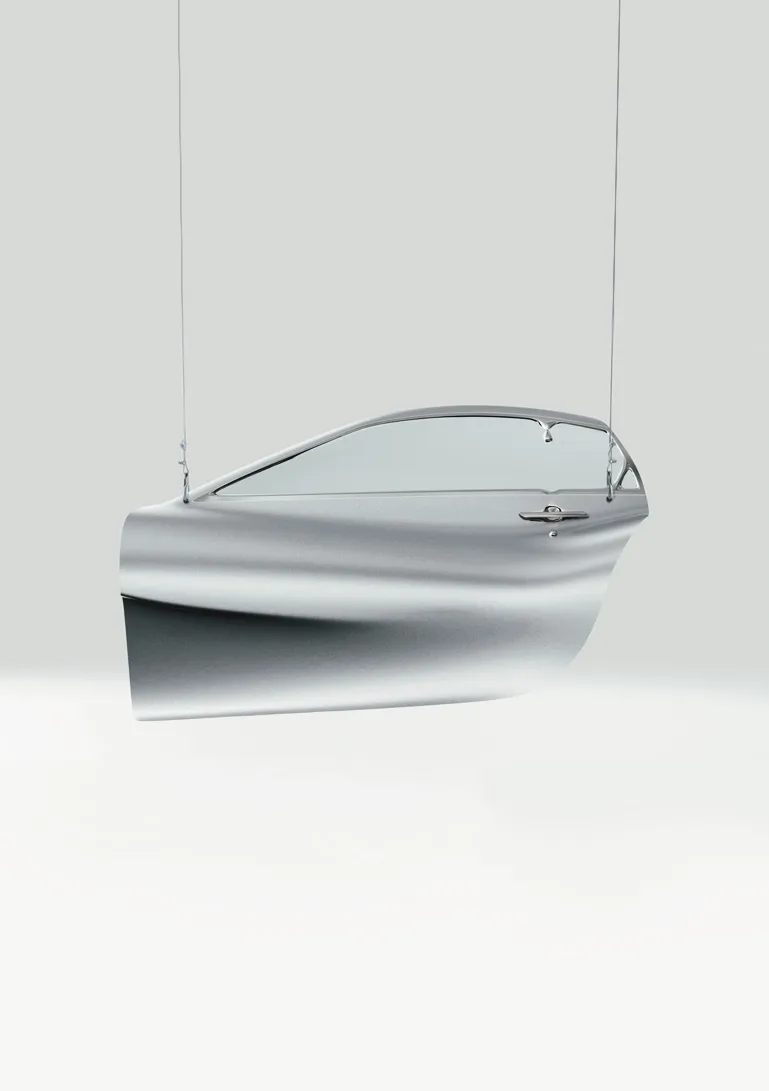 a car door hanging from two wires. 