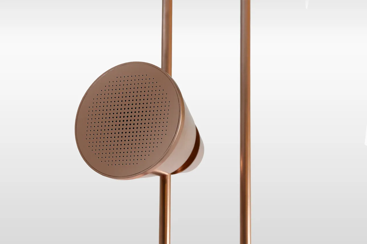 Cone-shaped speaker mounted on the vertical rail of a speaker system, shown from the front. Photo.