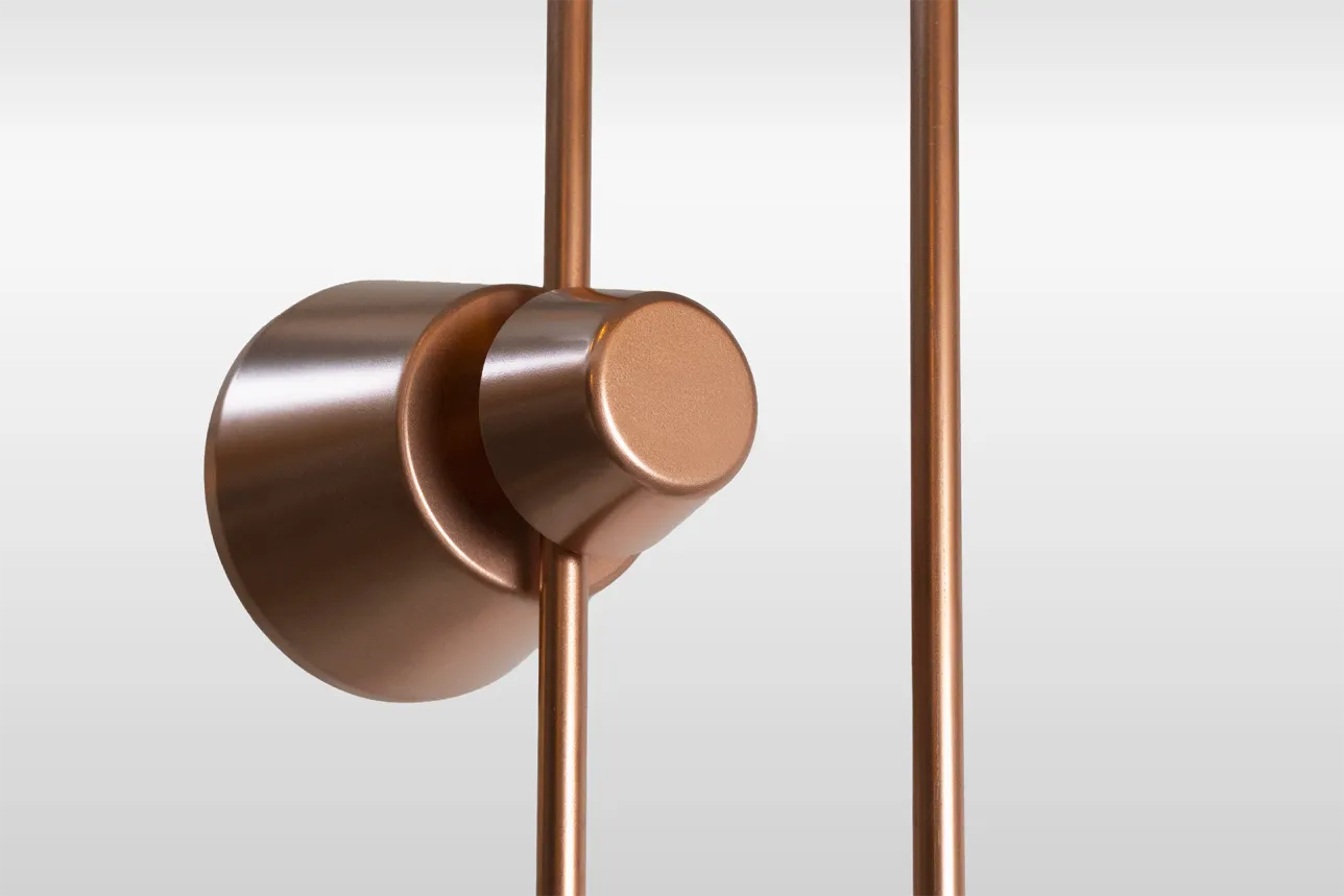 Cone-shaped speaker mounted on the vertical rail of a speaker system, shown from the back. Photo.