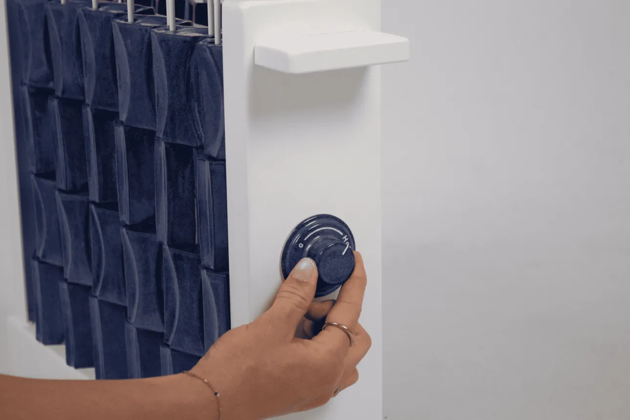 Close-up of person twisting the dial to hot. Photo. 