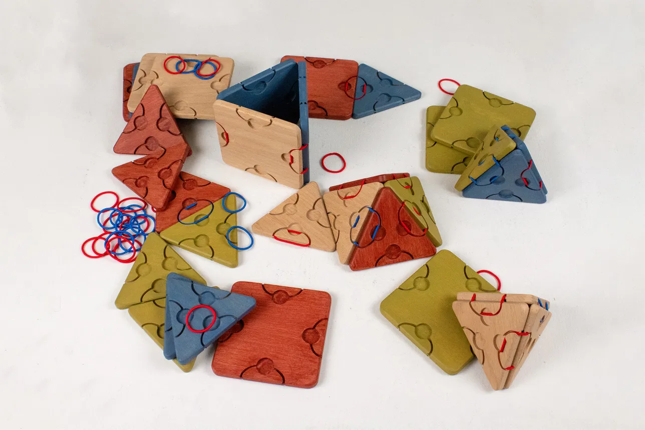 Triangles, squares and hair ties on a table. Photo. 