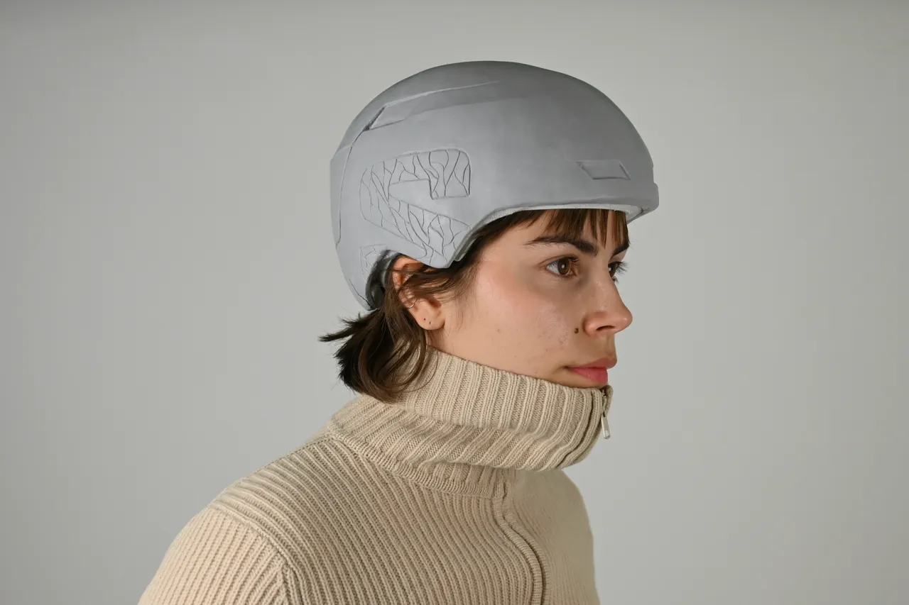 Person with a clay model of a ski helmet on their head. Photo.
