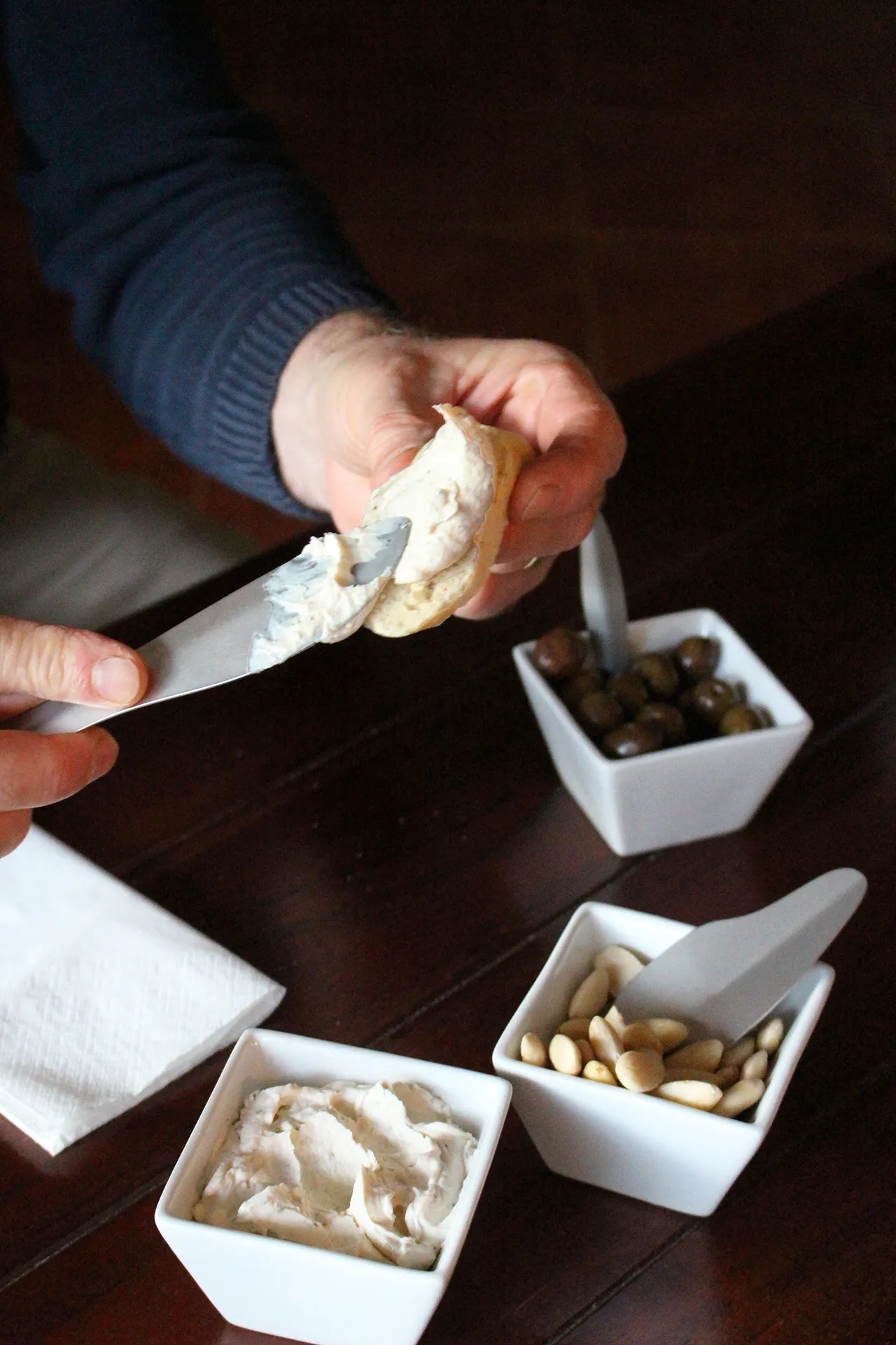 Dining table utensils in use with different snacks and drinks. Photo.