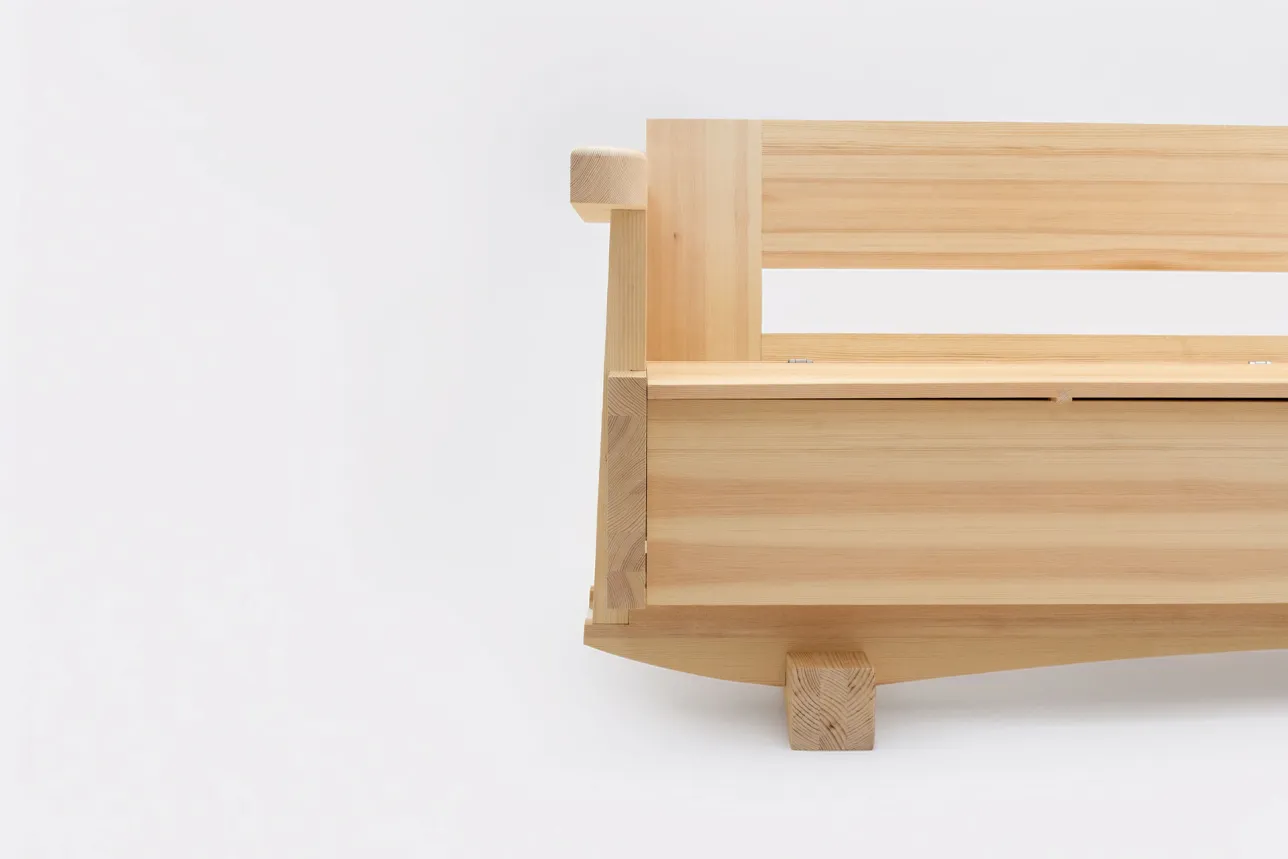 Half of the kitchen sofa is shown in a front view. Boxy pine construction. Photo. 